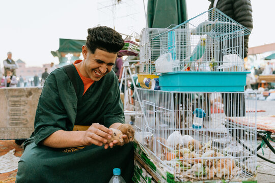 Laughing pet vendor in a moroccan market