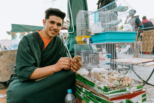 Portrait of a man selling animals in a market