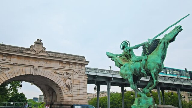 The best place for pictures with beautiful statue and view of the train in Paris, France. Tourist destination Bir-Hakeim bridge and France reborn statue with metro traffic.