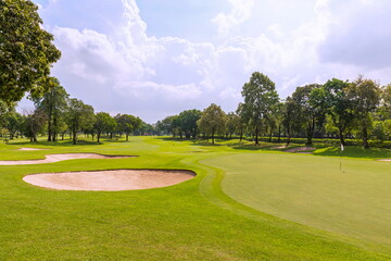 View of a golf course in Thailand with lush green grass, beautiful scenery with sand pits bunker ...
