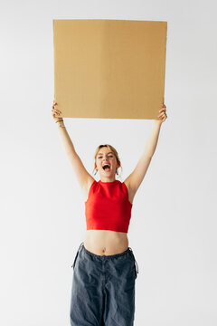 Cute Teenage Girl Holding Banner in Studio