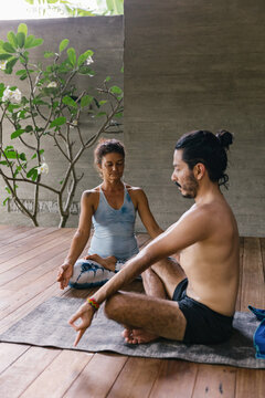 Two people meditating together at yoga studio