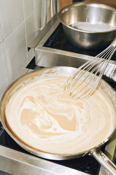 cooking bechamel sauce in a frying pan