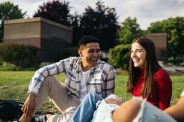 Multiracial group of young students in the campus gardens