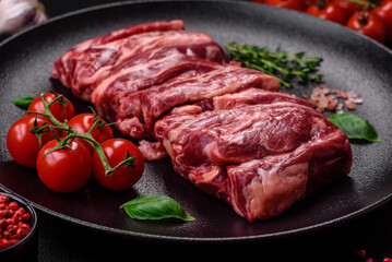 Fresh raw beef ribs with salt, spices and herbs