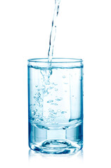 pouring water on a glass on white background
