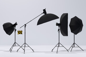 Photography studio flash on a lighting stand on white background