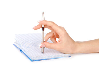Woman's hand with a pen writes in a notebook  isolated on a white background.
