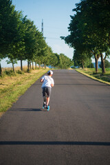 boy rides a scooter along a beautiful road