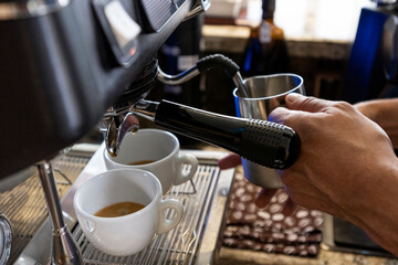 Man making coffee in a professional machine 