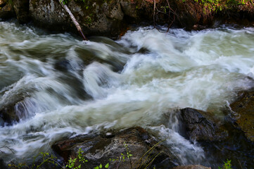 Fototapeta premium water flowing over rocks
