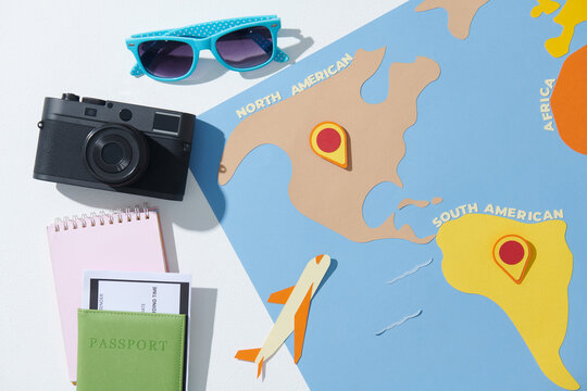 Summer weekend travel vacation accessories. Plane, passport, camera