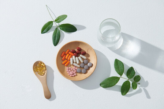Medical composition with health supplements on wooden spoons