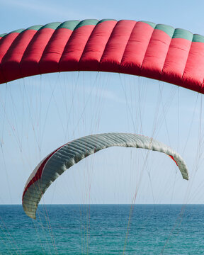 An abstract view of two paraglides against a blue sky 