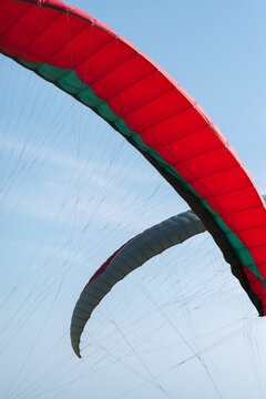 An abstract view of two paraglides against a blue sky 