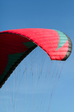 An abstract view of a paraglider against a blue sky 
