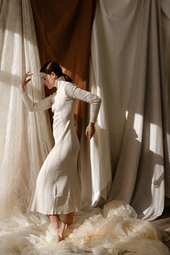 Asian woman in white dress dancing