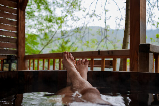 Anonymous man relaxing in a hot tub