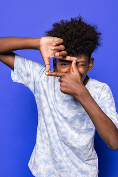 Black boy taking a virtual photo with hands