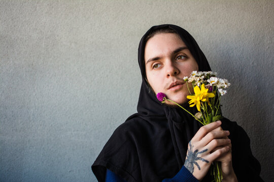 Non binary person with hijab and flowers portrait
