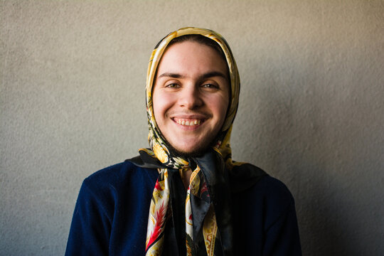 Transgender muslim person smiling at camera