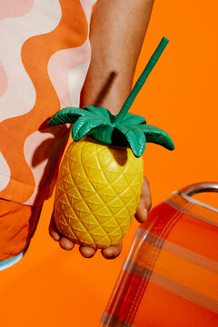 man with a pineapple-shaped cup