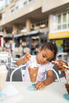 black girl eating ice cream outdoors in the city