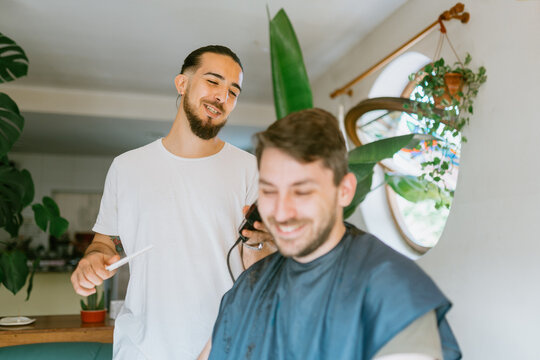 Barber talking to client while cutting his hair