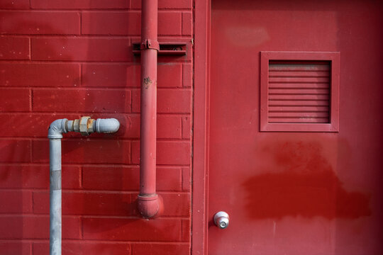 Stock image of painted red door and building