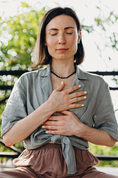 Female masseuse praying before massage