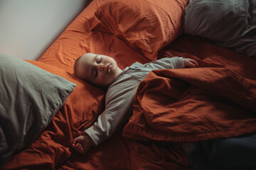 Baby asleep in adults bed