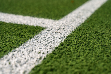 close-up view of artificial turf, lawn, sports field in a park with artificial grass and stretched...