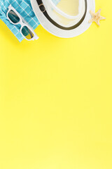 Beachwear and shellfish souvenirs on yellow background.