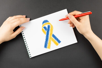 hands draw yellow blue ukraine ribbon