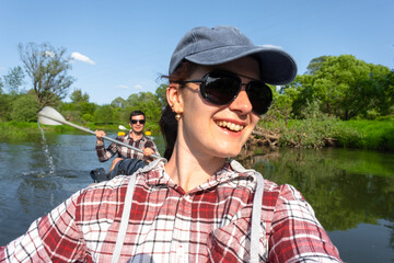 Man and woman couple, selfies are happy in family kayak trip rowing boat on the river, water hike,...