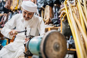 Professional master with hammer making leather belt