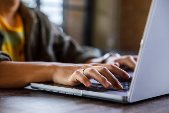 Hands of male freelancer working on laptop