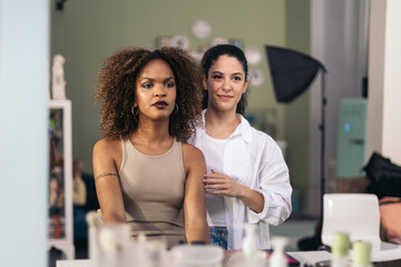 Make-up artist and model watching the make-up done in the mirror