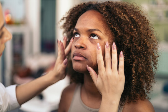 Professional makeup artist preparing the skin for makeup