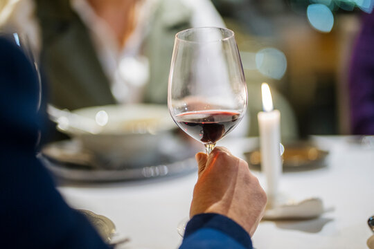Crop man with wineglass in restaurant