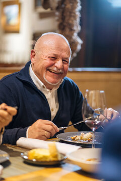 Senior man having dinner in restaurant