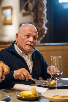 Middle aged man having dinner in restaurant