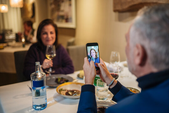 Anonymous man shooting photo of wife during date