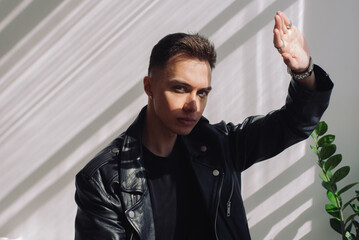 Young man hides his face from sun rays