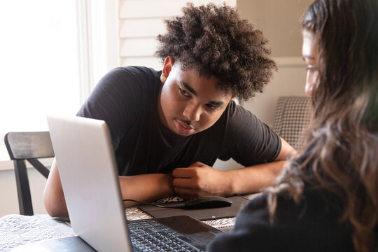 Diverse group of teenagers studying together at home 