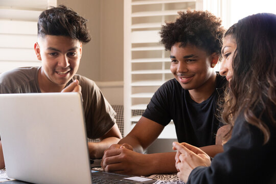 Diverse group of teenagers studying together at home 