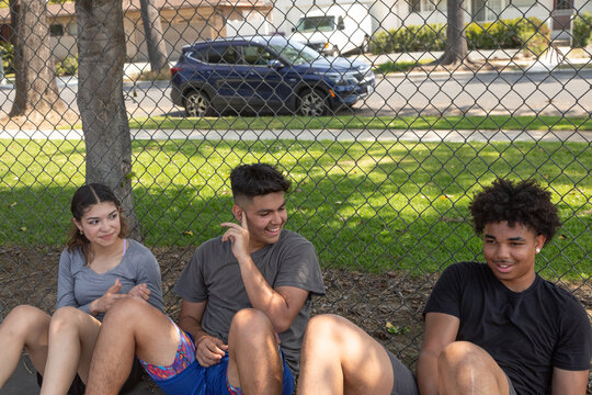 Friends sitting together after playing basketball