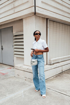 Woman downtown in white button up crop top