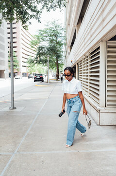 Woman downtown in white button up crop top