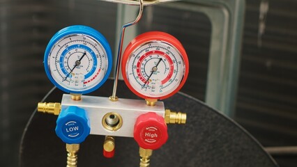 Close up shot of pressure measurement device used for checking condenser freon pressure. Set of...